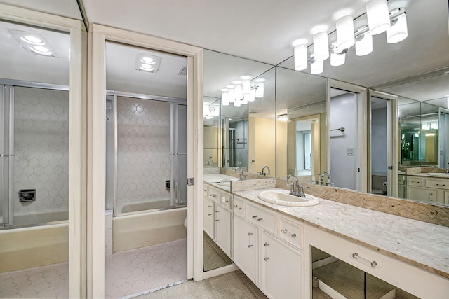 bathroom featuring vanity, tile patterned floors, and bath / shower combo with glass door