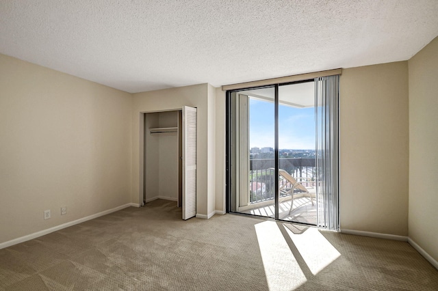 unfurnished bedroom with light carpet, a textured ceiling, access to outside, and a closet