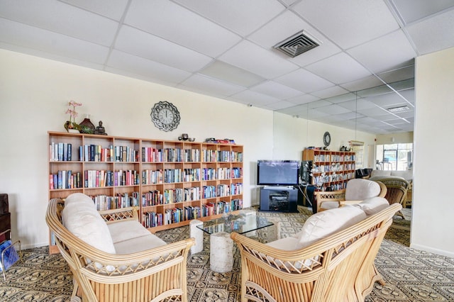 sitting room featuring a paneled ceiling