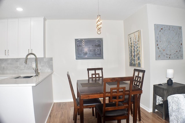 dining area with wood finished floors and baseboards