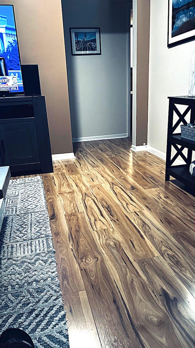 interior space featuring wood finished floors and baseboards