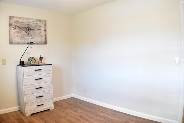 unfurnished bedroom featuring baseboards and wood finished floors