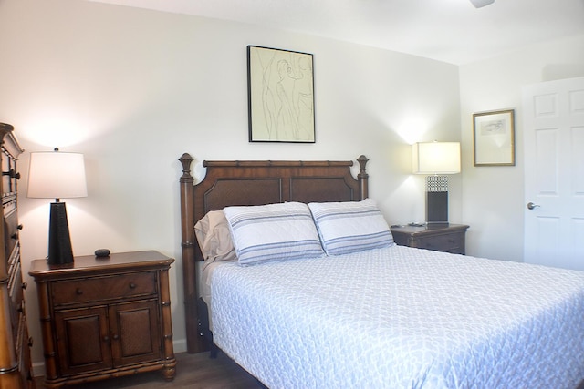 bedroom with dark wood-type flooring