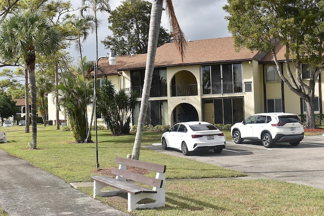 view of building exterior with uncovered parking