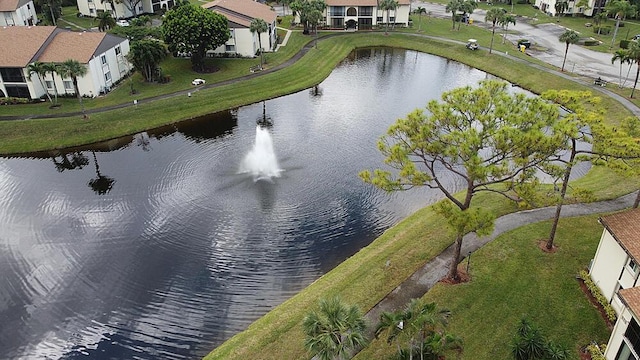 drone / aerial view featuring a residential view and a water view