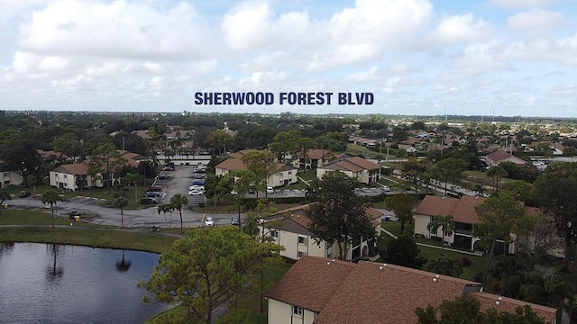 drone / aerial view featuring a water view and a residential view