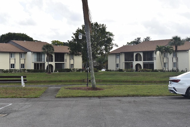 exterior space featuring a front lawn and stucco siding