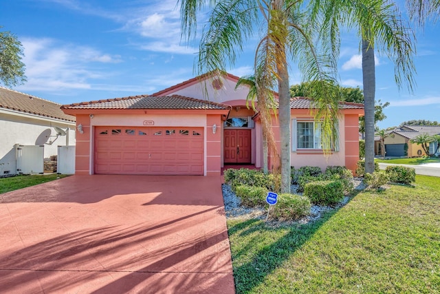 mediterranean / spanish house featuring a front yard and a garage