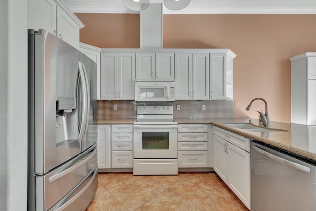 kitchen with white cabinets, sink, stainless steel appliances, and tasteful backsplash