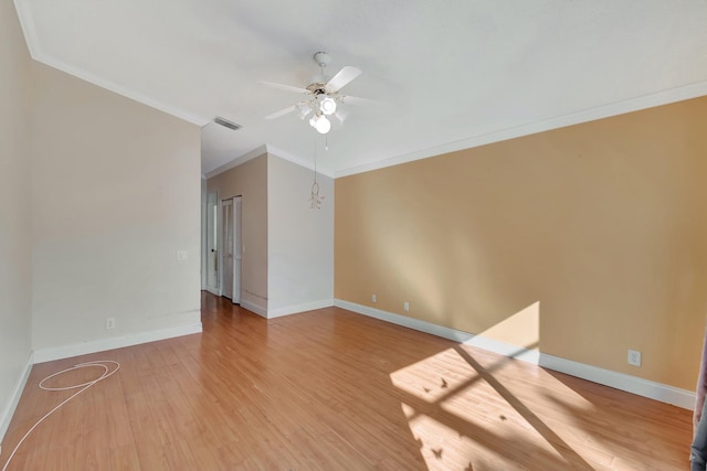 unfurnished room featuring ceiling fan with notable chandelier, wood-type flooring, and crown molding