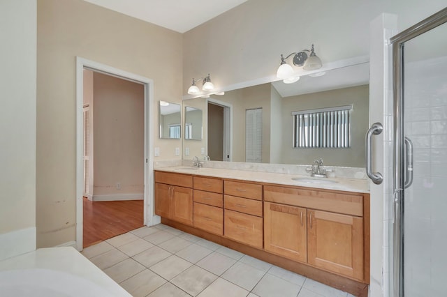 bathroom with tile patterned flooring, vanity, and an enclosed shower