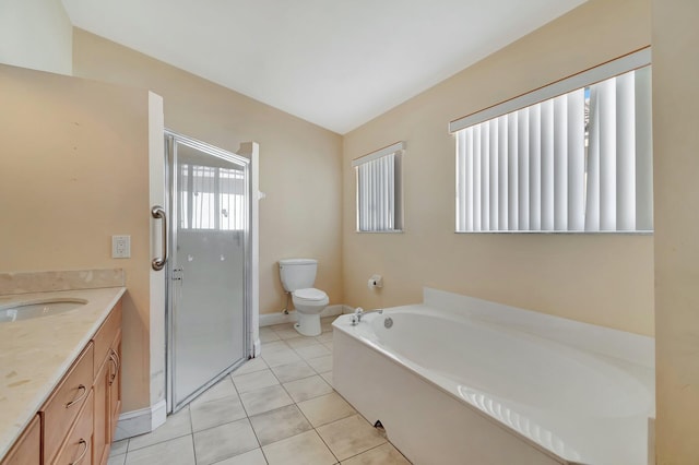 bathroom with vanity, a bathing tub, vaulted ceiling, tile patterned flooring, and toilet