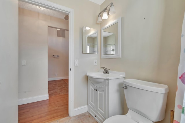 bathroom featuring tile patterned floors, vanity, and toilet