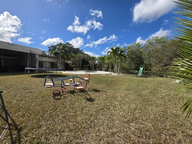 surrounding community with playground community, a trampoline, and a yard