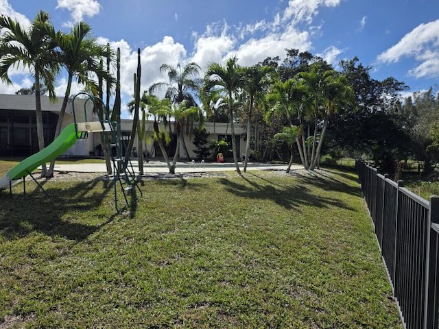 community playground with a lawn and fence