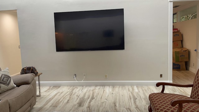 sitting room with wood finished floors and baseboards