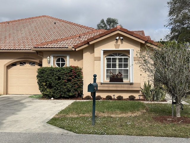 mediterranean / spanish-style house with a garage