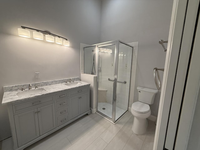 bathroom with vanity, an enclosed shower, and toilet