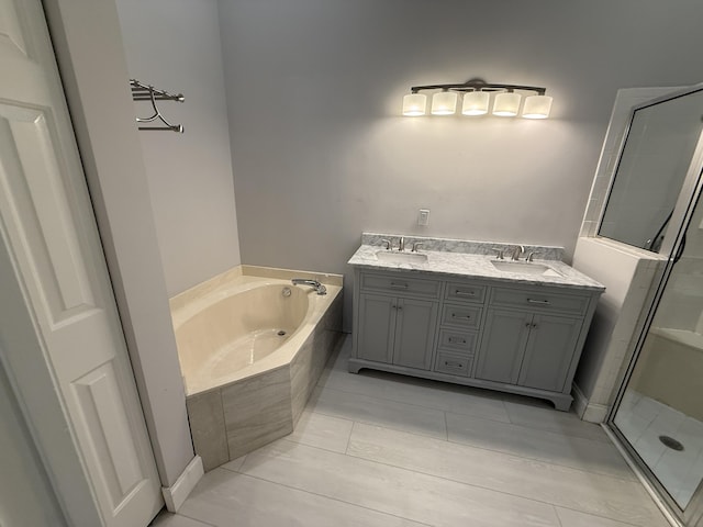 bathroom featuring vanity and shower with separate bathtub