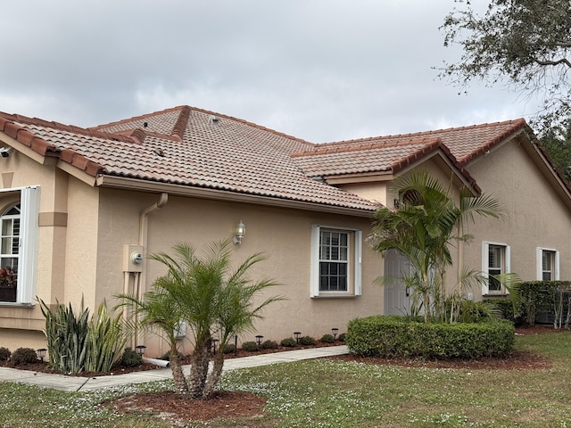 view of property exterior featuring a lawn