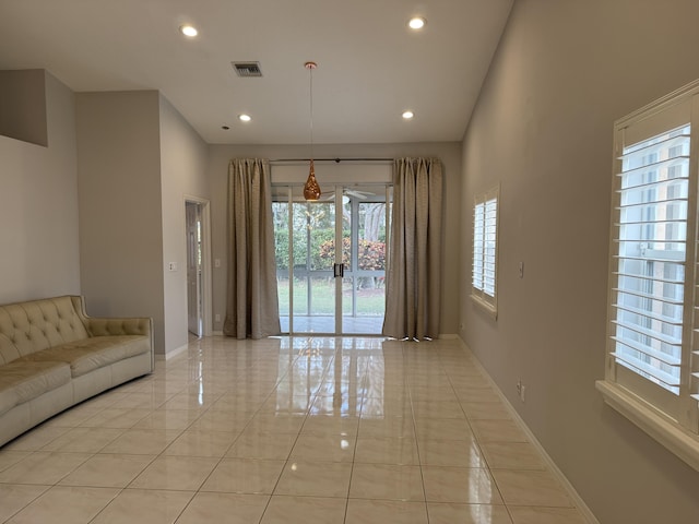 unfurnished living room with light tile patterned floors