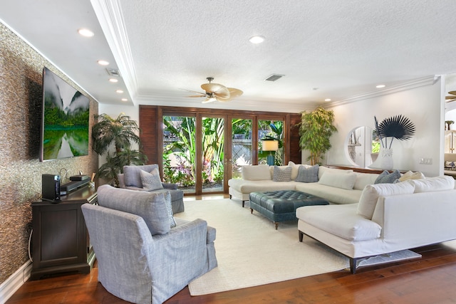 living room featuring a textured ceiling, dark hardwood / wood-style flooring, ceiling fan, and crown molding