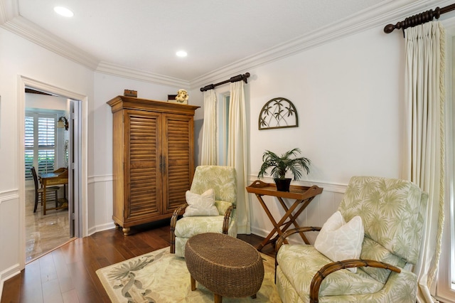 living area with crown molding and dark wood-type flooring