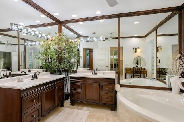 bathroom with vanity, tiled bath, ceiling fan, and ornamental molding