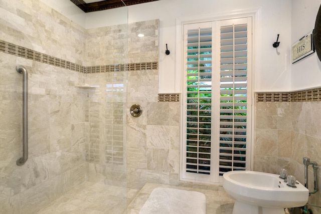 bathroom with a tile shower, a bidet, and tile walls