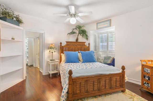 bedroom with dark hardwood / wood-style floors and ceiling fan