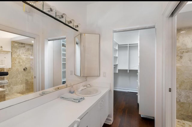 bathroom featuring wood-type flooring, vanity, and walk in shower