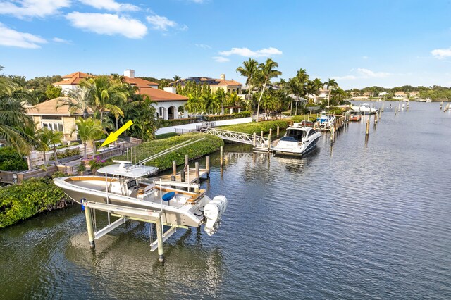 dock area featuring boat lift and a water view