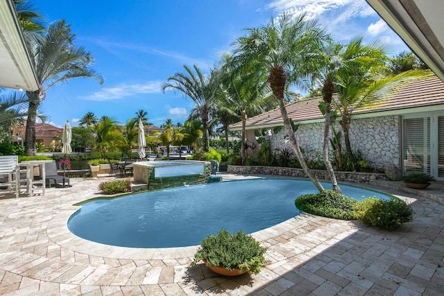 view of pool featuring pool water feature and a patio area