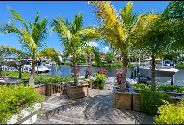 deck with a dock and a water view