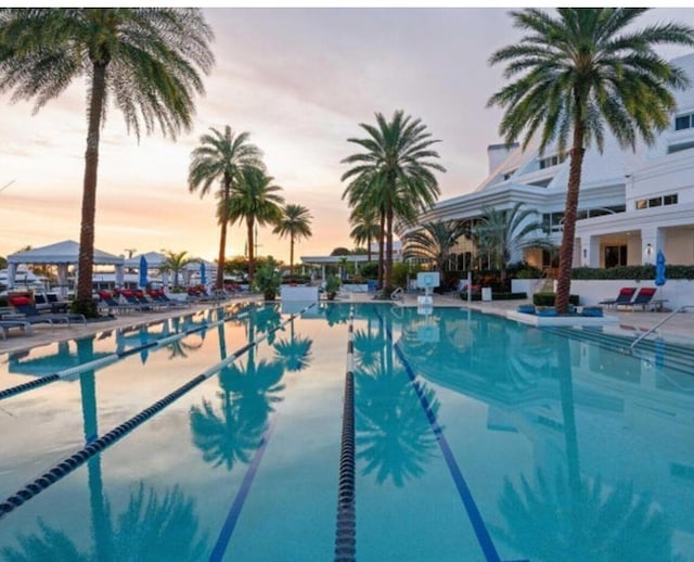 pool at dusk with a patio