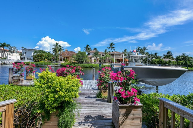 view of home's community featuring a residential view, a water view, a dock, and boat lift