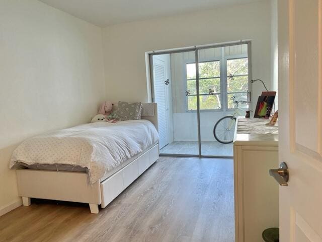 bedroom with a closet and light hardwood / wood-style flooring