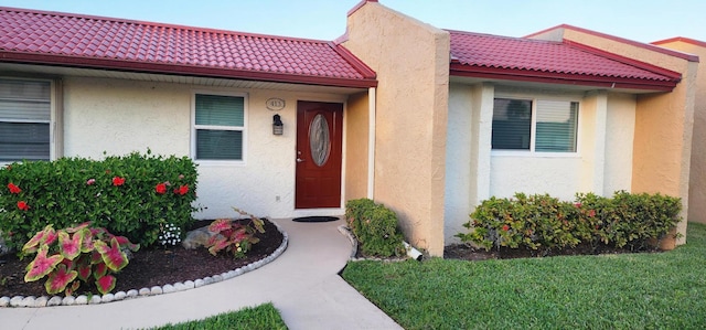 entrance to property with a yard