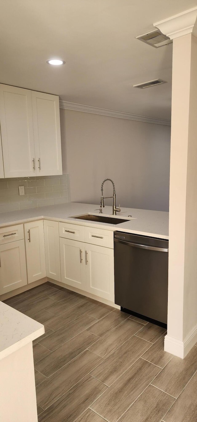 kitchen with white cabinetry, sink, dishwasher, and light wood-type flooring