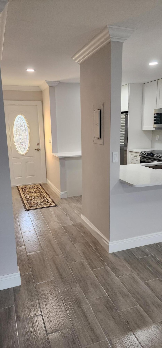 entrance foyer with electric panel and hardwood / wood-style flooring