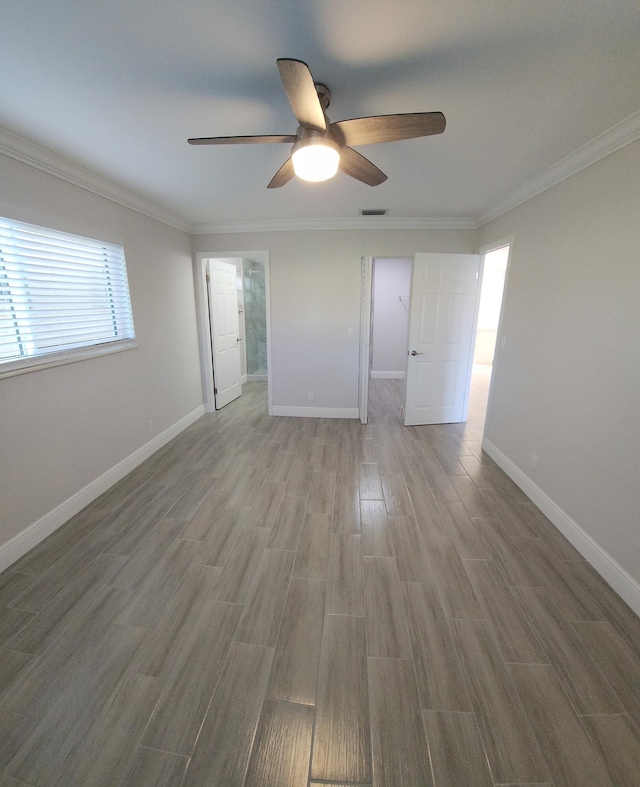 empty room with ceiling fan, hardwood / wood-style floors, and ornamental molding