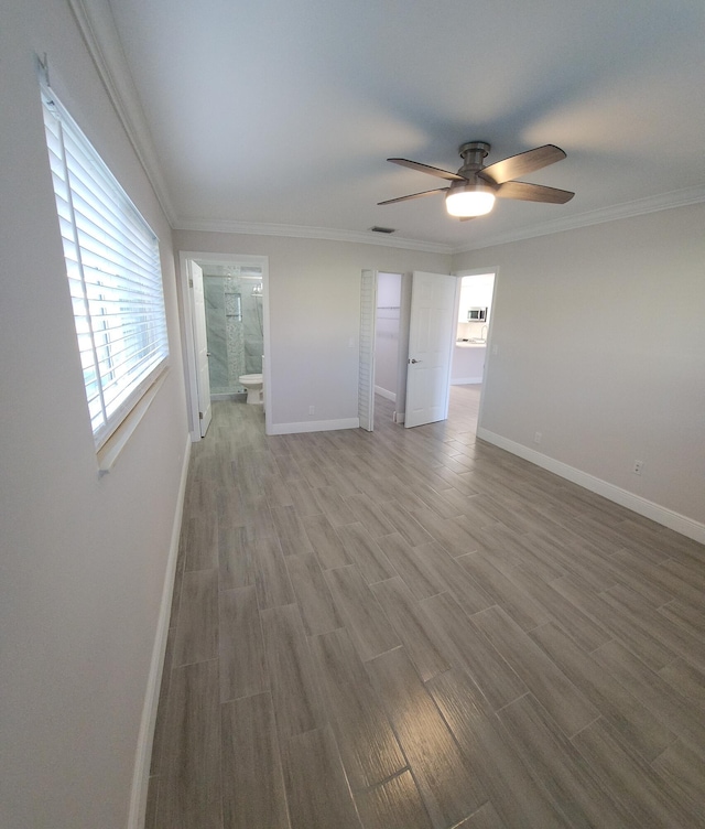 unfurnished room featuring ceiling fan, crown molding, and hardwood / wood-style flooring