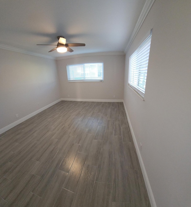 spare room featuring crown molding, dark hardwood / wood-style flooring, and a healthy amount of sunlight