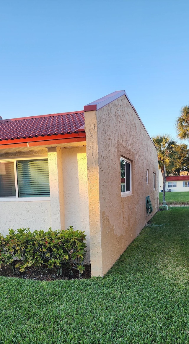 view of side of home with a lawn