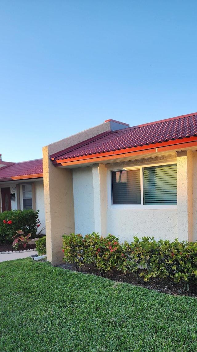 view of side of home featuring a yard