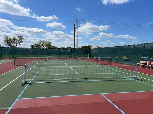 view of tennis court with basketball hoop