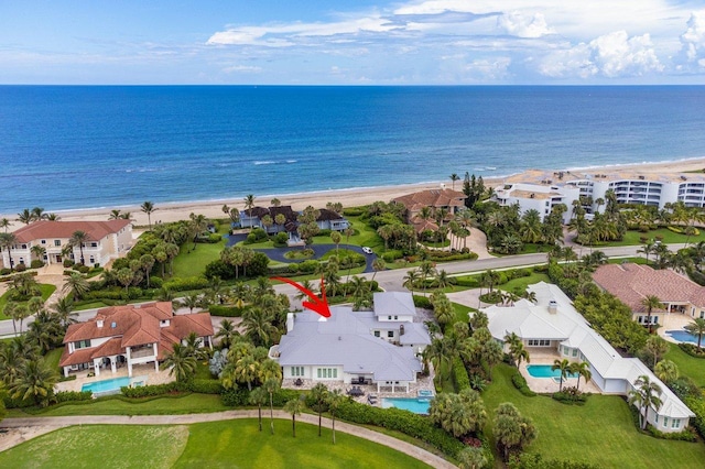 bird's eye view featuring a water view and a beach view