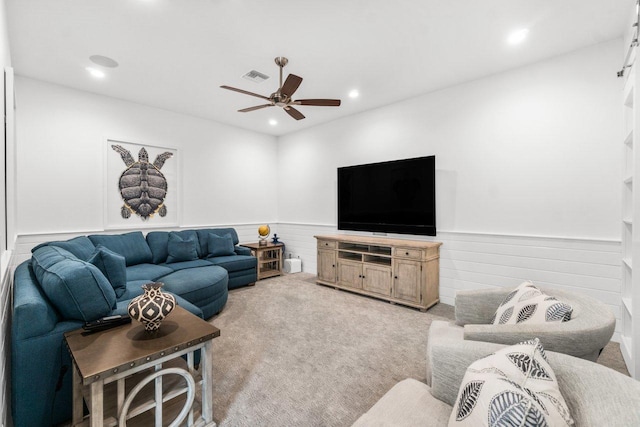 carpeted living room featuring ceiling fan