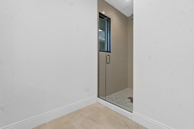 bathroom featuring a shower with shower door