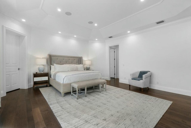 bedroom featuring wood-type flooring, ornamental molding, and a tray ceiling